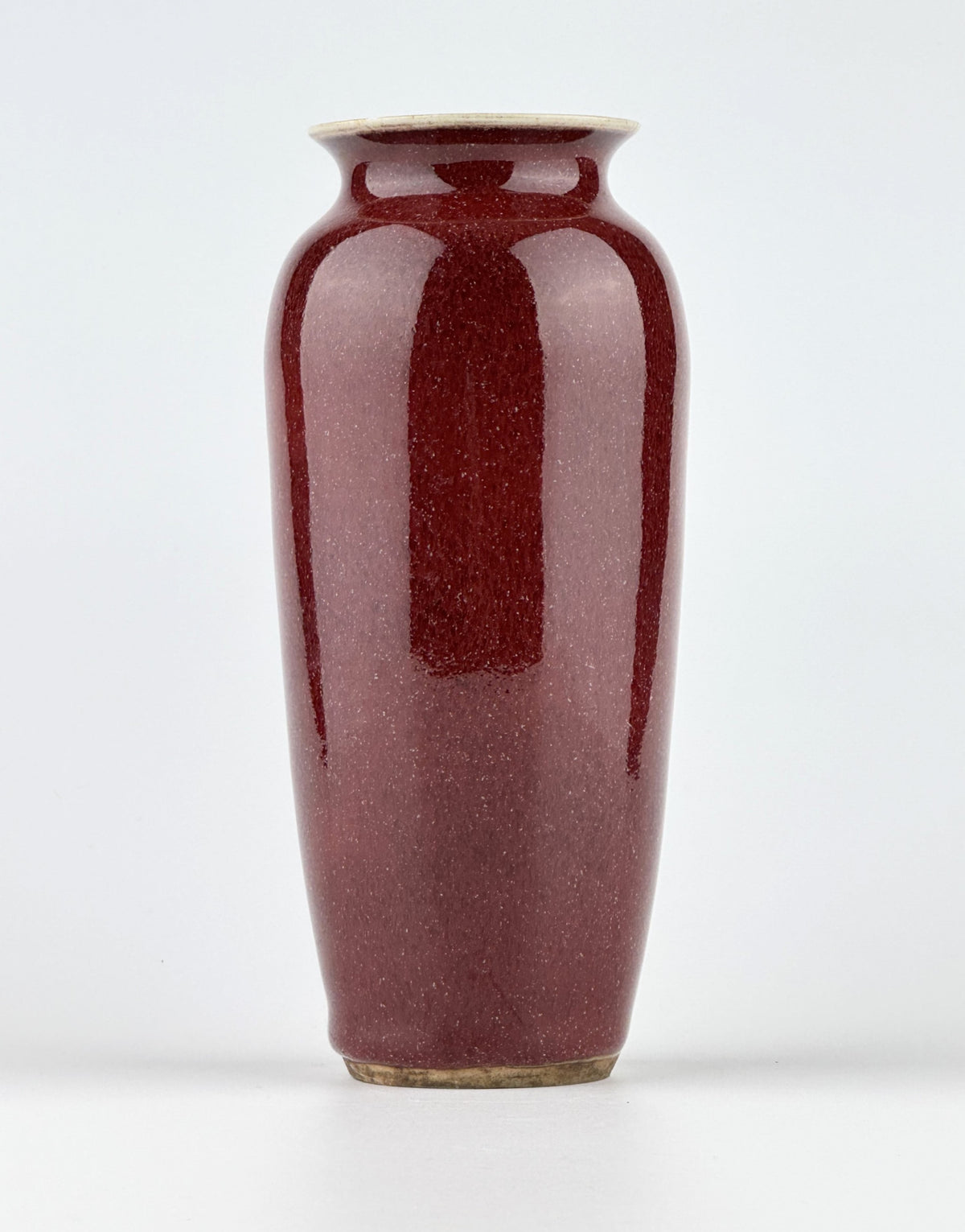 Qing Dynasty Langyao copper-red glazed porcelain vase with glossy purplish-red glaze and elegant balanced form.