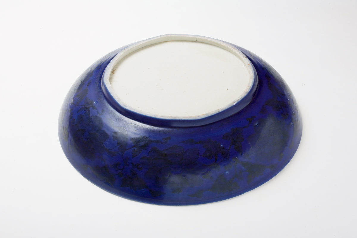 Large Qing Dynasty cobalt-blue glazed porcelain dish with rockwork and floral motifs, shipwreck-recovered, Kangxi-Yongzheng period.