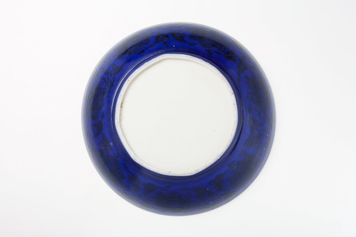 Large Qing Dynasty cobalt-blue glazed porcelain dish with rockwork and floral motifs, shipwreck-recovered, Kangxi-Yongzheng period.