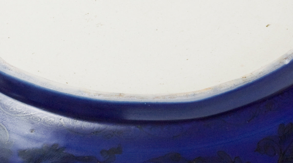 Large Qing Dynasty cobalt-blue glazed porcelain dish with rockwork and floral motifs, shipwreck-recovered, Kangxi-Yongzheng period.