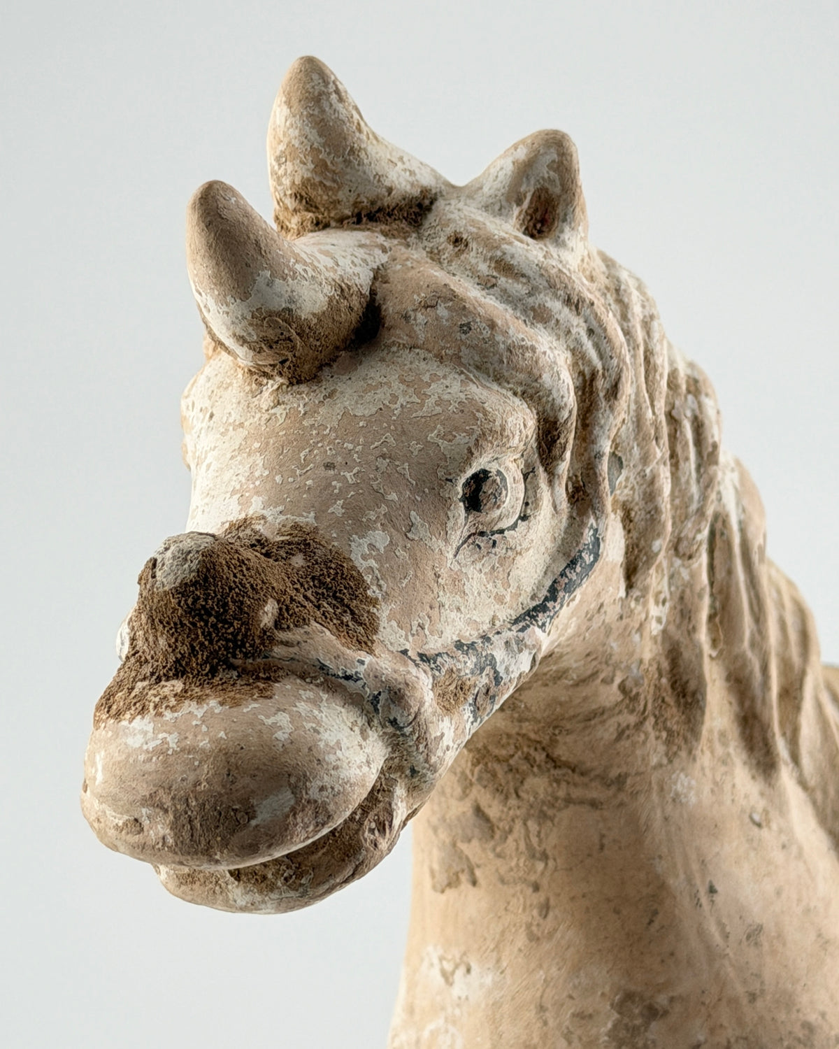Ming Dynasty pottery horse figure with green-glazed saddle and harness, standing on a rectangular base with aged burial patina.