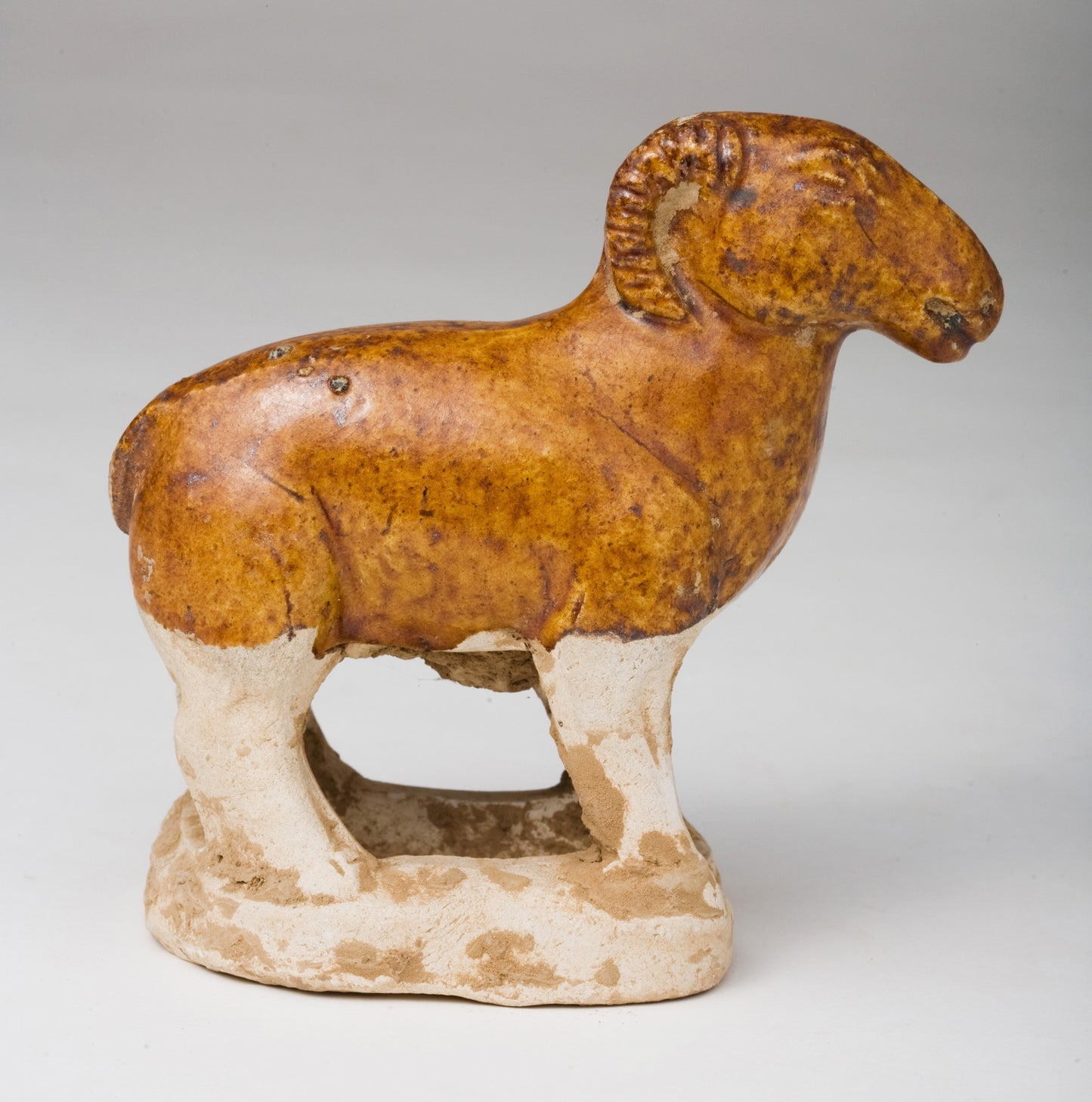 AMBER-GLAZED POTTERY FIGURE OF SHEEP, TANG-LIAO DYNASTY (7-12TH CENTURY)