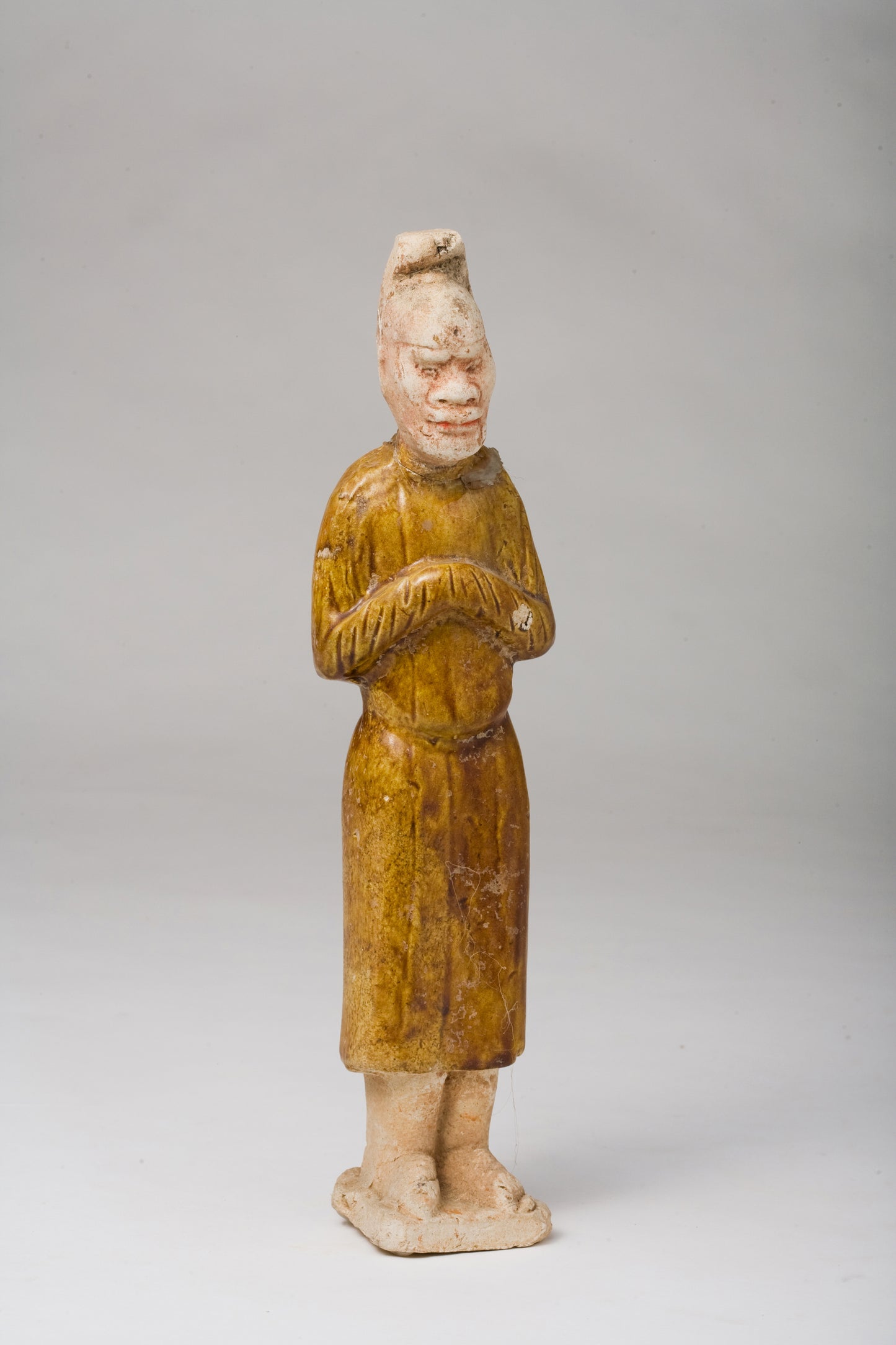 AMBER-GLAZED POTTERY FIGURE OF AN FOREIGN OFFICIAL, TANG-LIAO DYNASTY (7-12TH CENTURY)