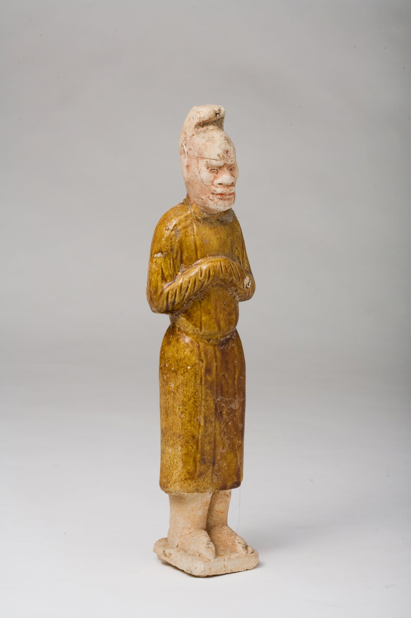 AMBER-GLAZED POTTERY FIGURE OF AN FOREIGN OFFICIAL, TANG-LIAO DYNASTY (7-12TH CENTURY)