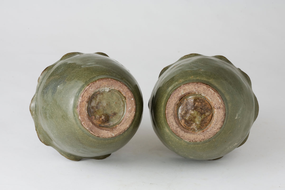 Pair of olive-green Longquan celadon vases with sculpted bird, mystical beasts, Sui-Song Dynasty.
