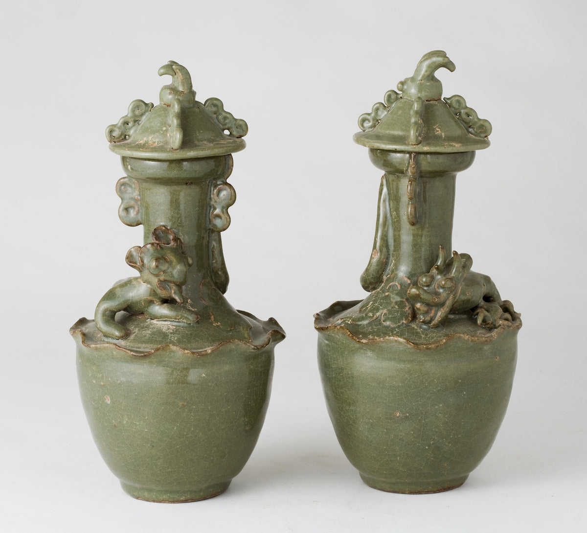 Pair of olive-green Longquan celadon vases with sculpted bird, mystical beasts, Sui-Song Dynasty.