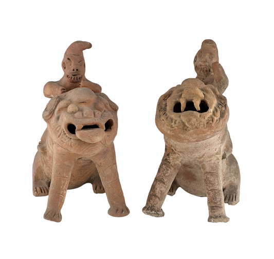 Pair of Chinese earthenware rider figures on fierce mythical lions, possibly Qing Dynasty or earlier, with open-mouthed beasts.