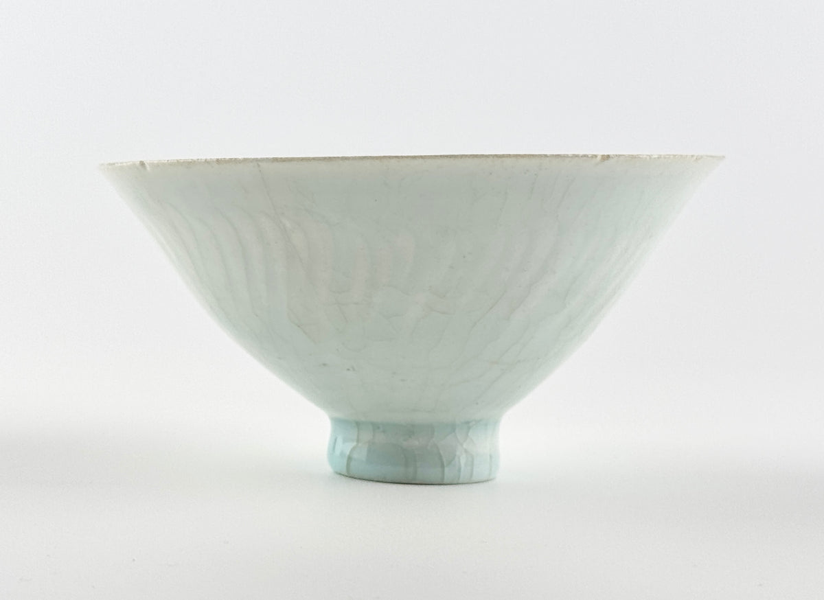 Southern Song-Yuan Qingbai porcelain conical bowl with pale bluish glaze, lotus-petal relief, and natural crackling.