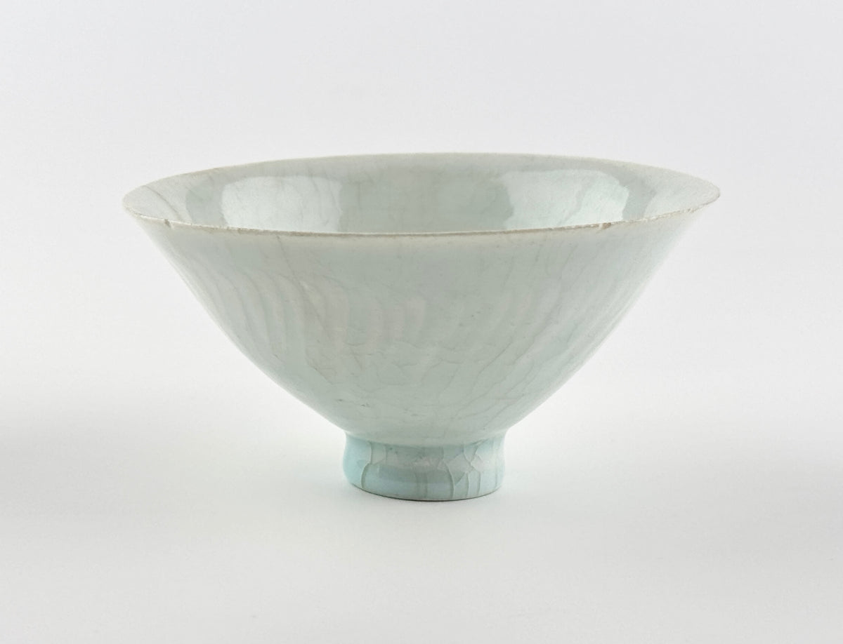 Southern Song-Yuan Qingbai porcelain conical bowl with pale bluish glaze, lotus-petal relief, and natural crackling.