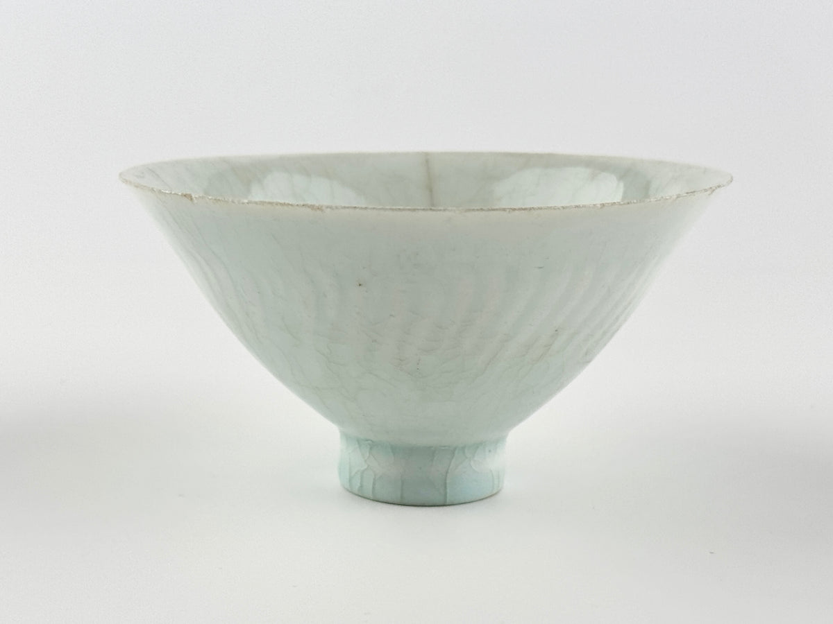 Southern Song-Yuan Qingbai porcelain conical bowl with pale bluish glaze, lotus-petal relief, and natural crackling.