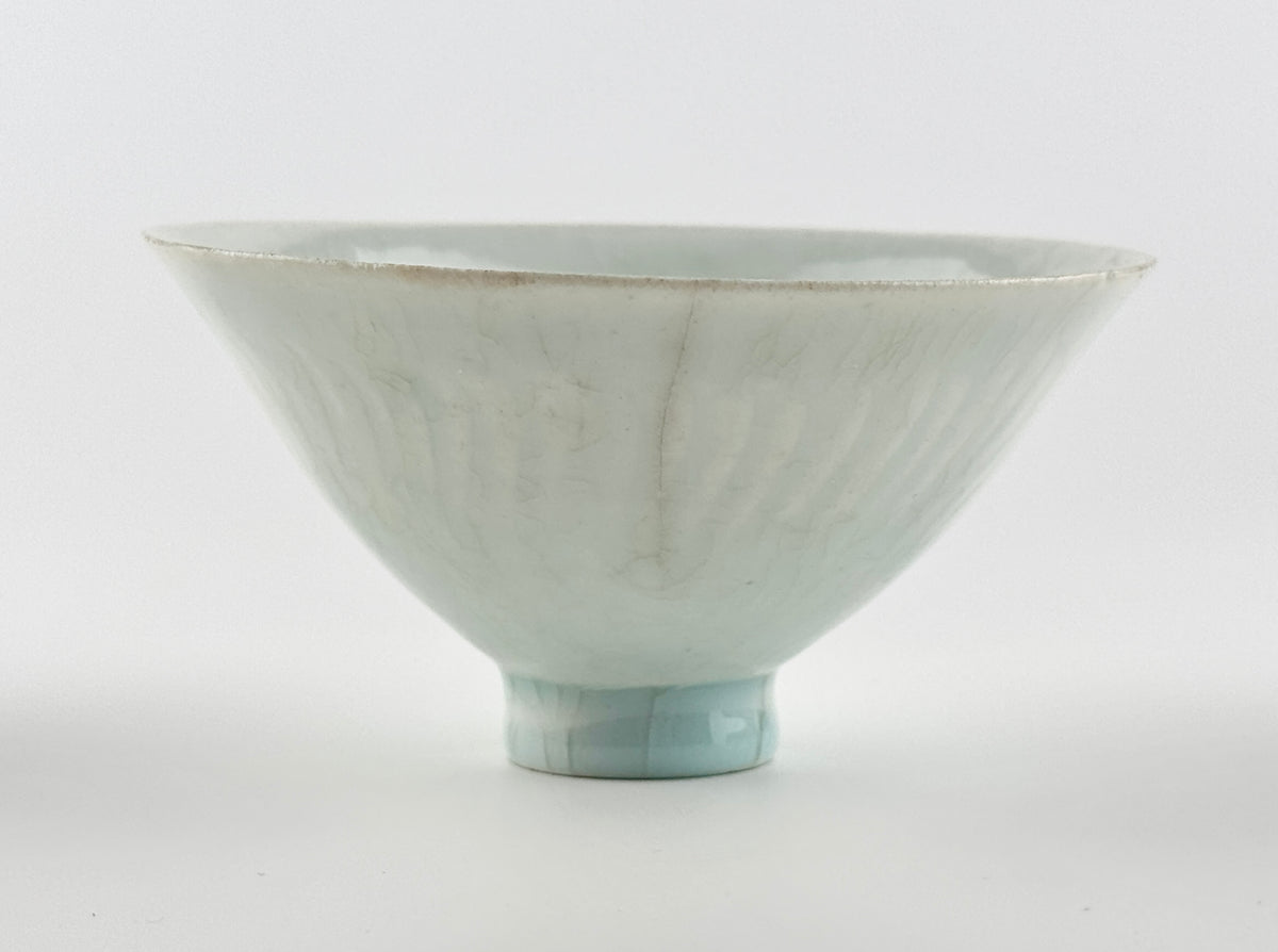 Southern Song-Yuan Qingbai porcelain conical bowl with pale bluish glaze, lotus-petal relief, and natural crackling.