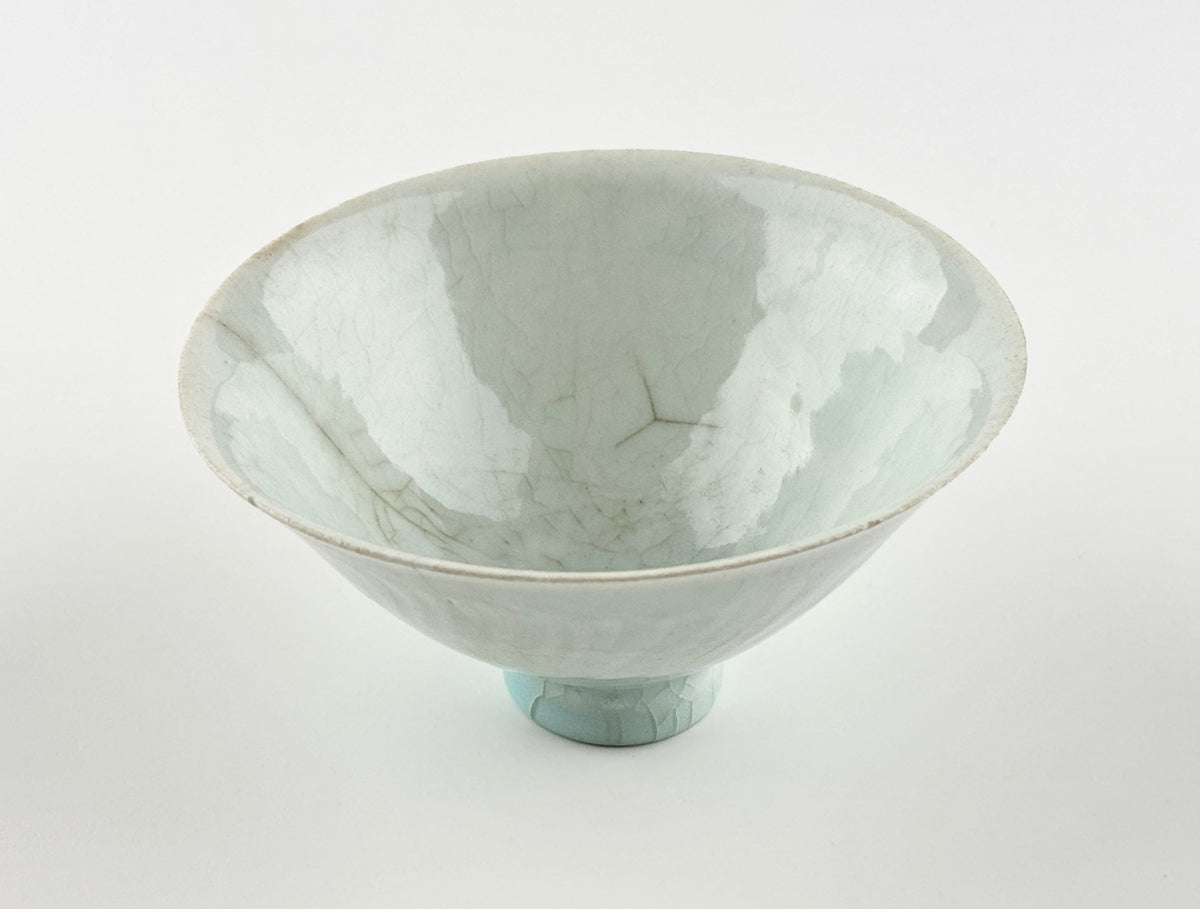 Southern Song-Yuan Qingbai porcelain conical bowl with pale bluish glaze, lotus-petal relief, and natural crackling.