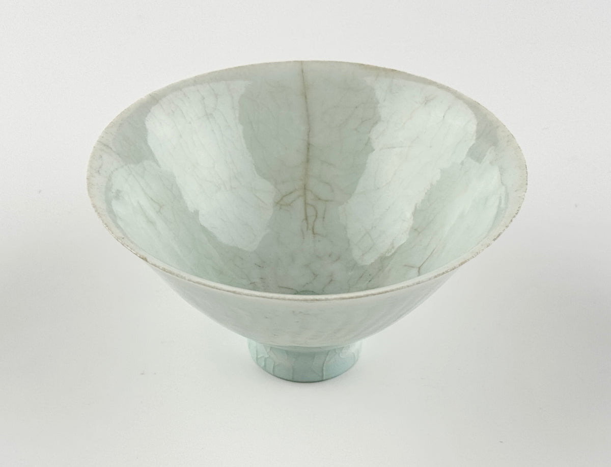 Southern Song-Yuan Qingbai porcelain conical bowl with pale bluish glaze, lotus-petal relief, and natural crackling.