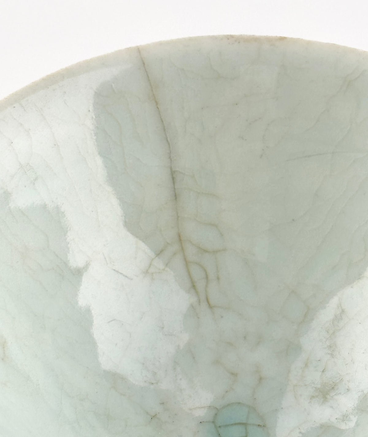 Southern Song-Yuan Qingbai porcelain conical bowl with pale bluish glaze, lotus-petal relief, and natural crackling.