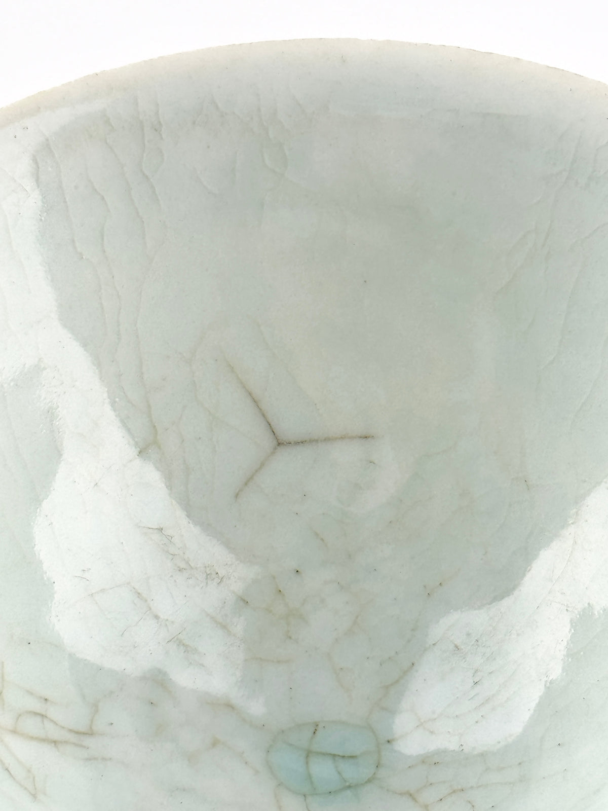 Southern Song-Yuan Qingbai porcelain conical bowl with pale bluish glaze, lotus-petal relief, and natural crackling.