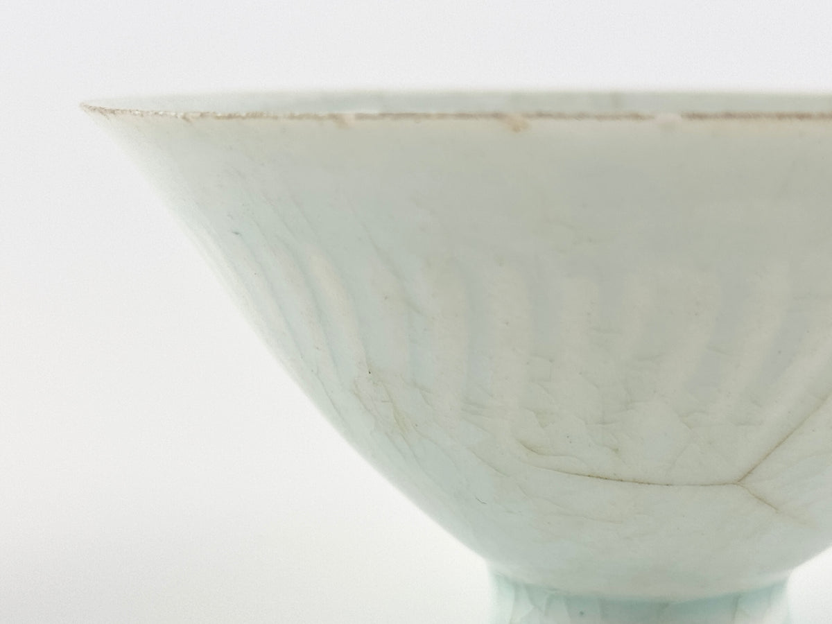 Southern Song-Yuan Qingbai porcelain conical bowl with pale bluish glaze, lotus-petal relief, and natural crackling.
