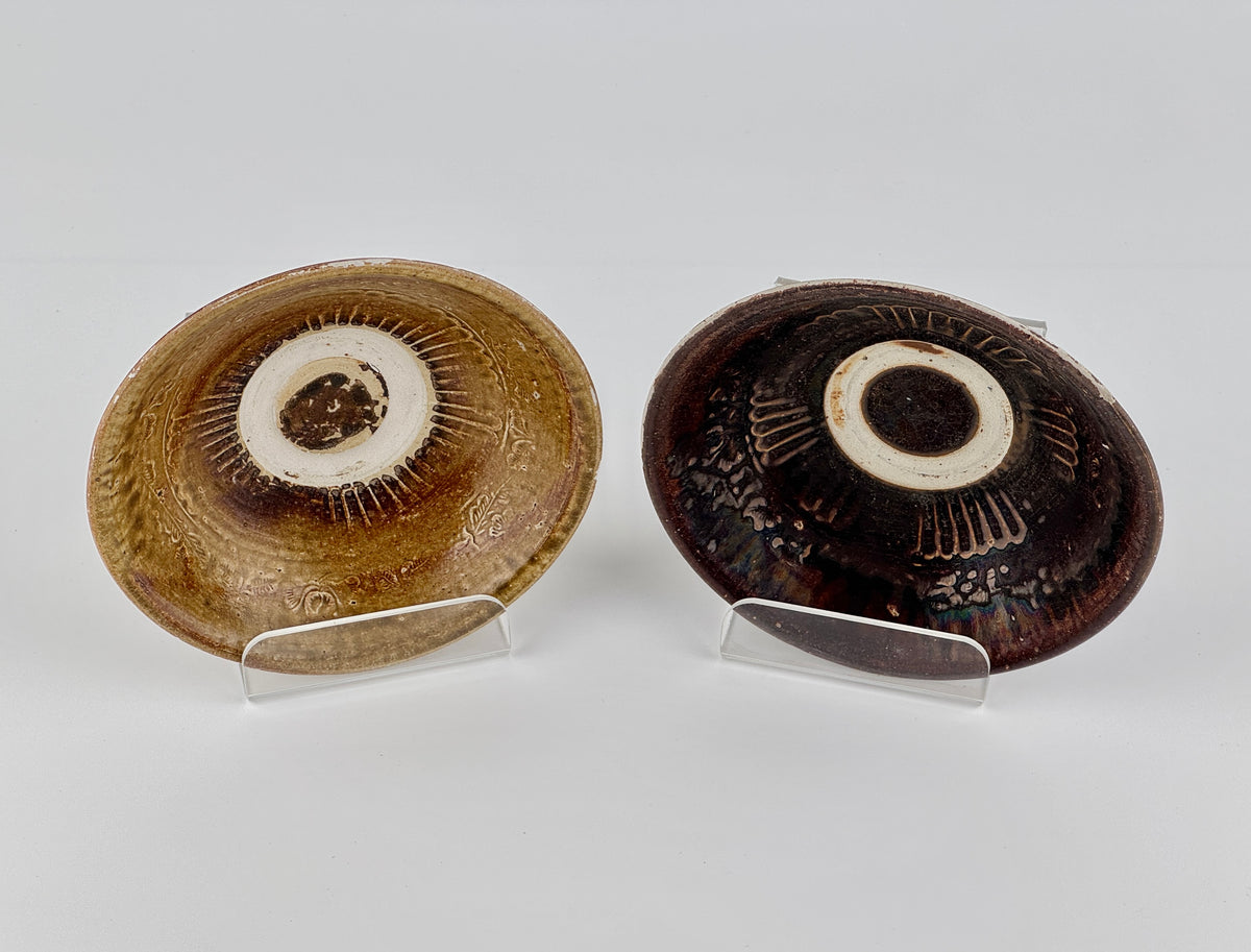 Pair of 15th-century Vietnamese Annamese stoneware bowls with carved floral decoration and olive-green to iron-brown glaze.