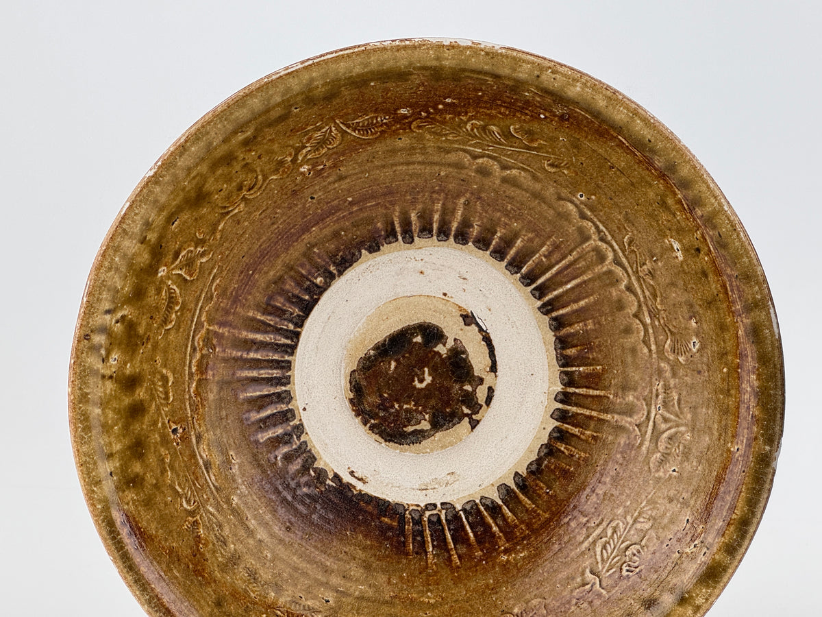 Pair of 15th-century Vietnamese Annamese stoneware bowls with carved floral decoration and olive-green to iron-brown glaze.