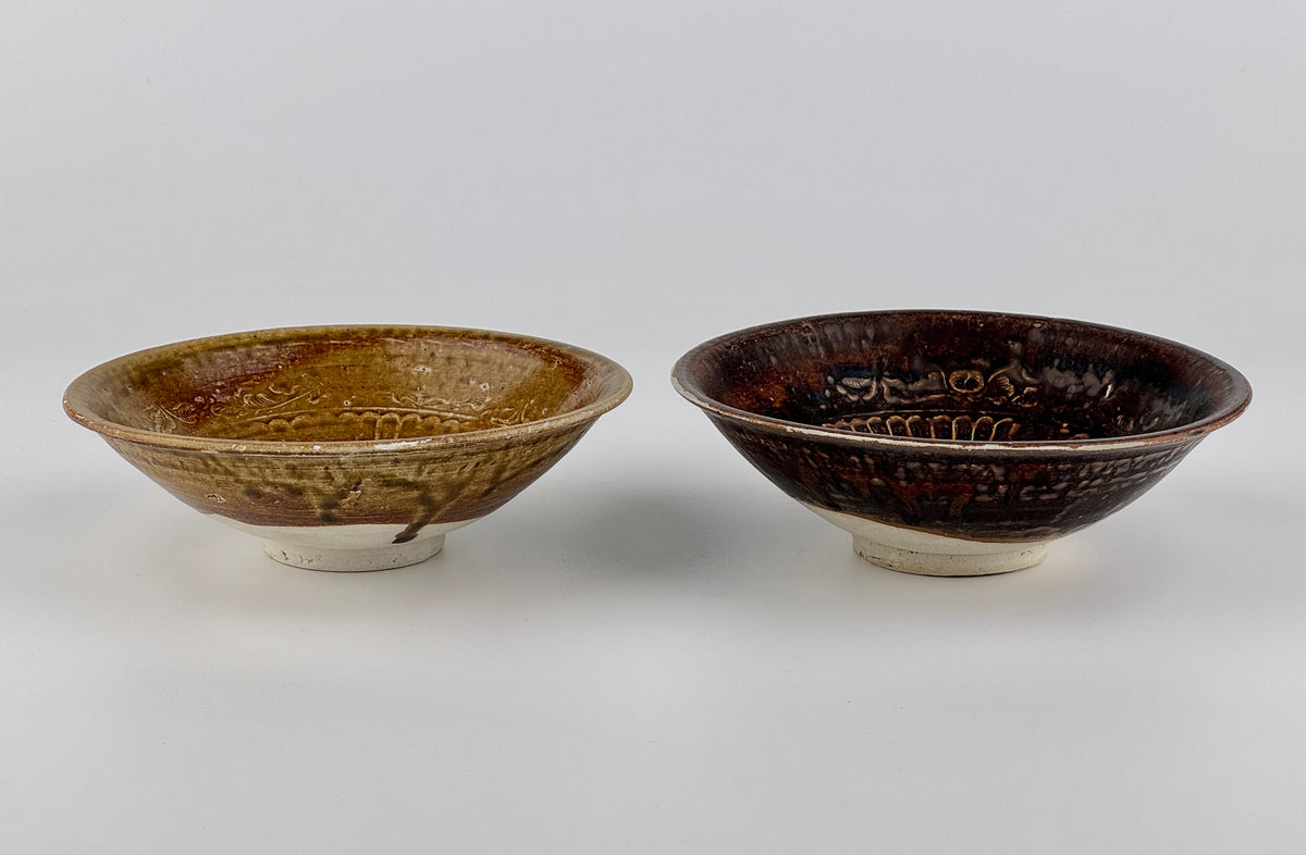 Pair of 15th-century Vietnamese Annamese stoneware bowls with carved floral decoration and olive-green to iron-brown glaze.
