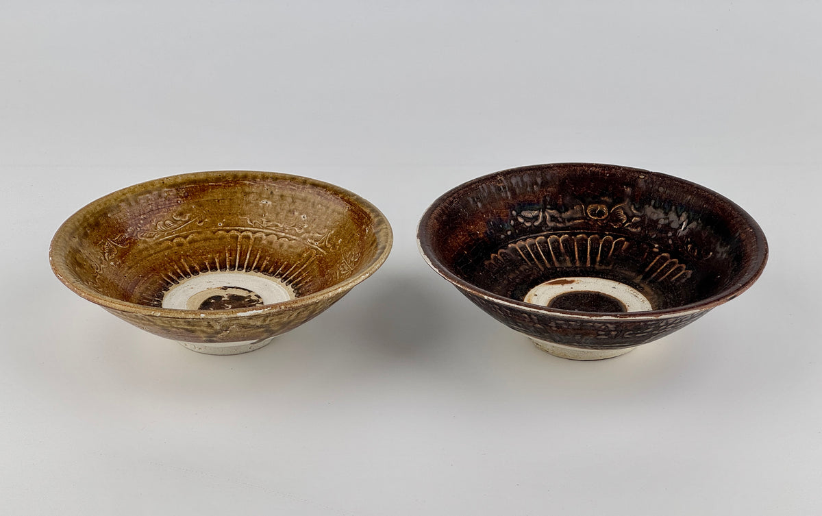 Pair of 15th-century Vietnamese Annamese stoneware bowls with carved floral decoration and olive-green to iron-brown glaze.
