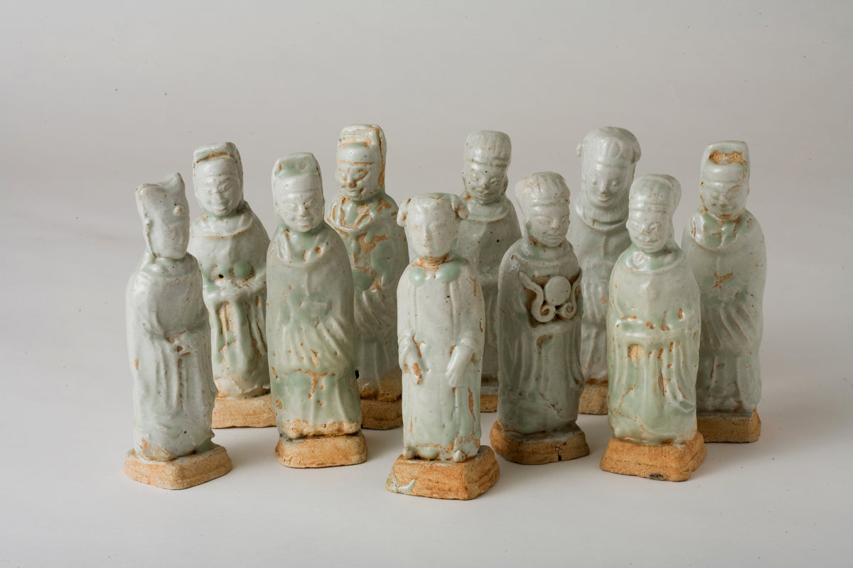 Ten Qingbai porcelain courtier figurines, Five Dynasties to Song Dynasty, with official robes and square pedestals.