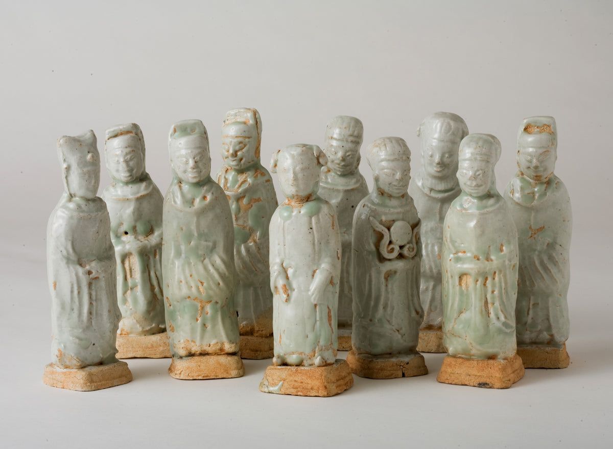 Ten Qingbai porcelain courtier figurines, Five Dynasties to Song Dynasty, with official robes and square pedestals.