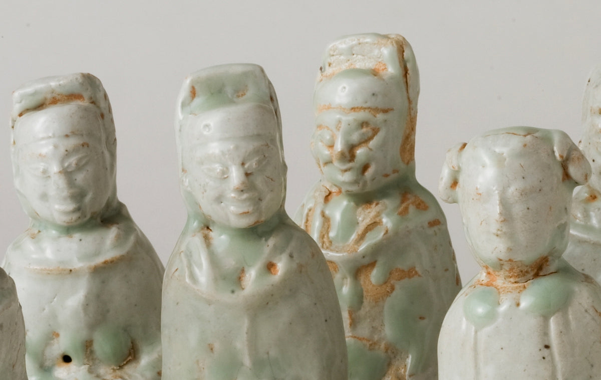 Ten Qingbai porcelain courtier figurines, Five Dynasties to Song Dynasty, with official robes and square pedestals.