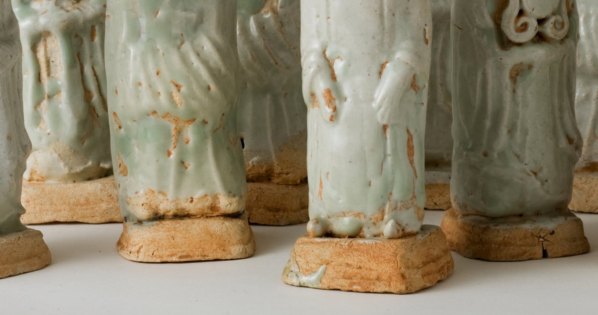 Ten Qingbai porcelain courtier figurines, Five Dynasties to Song Dynasty, with official robes and square pedestals.