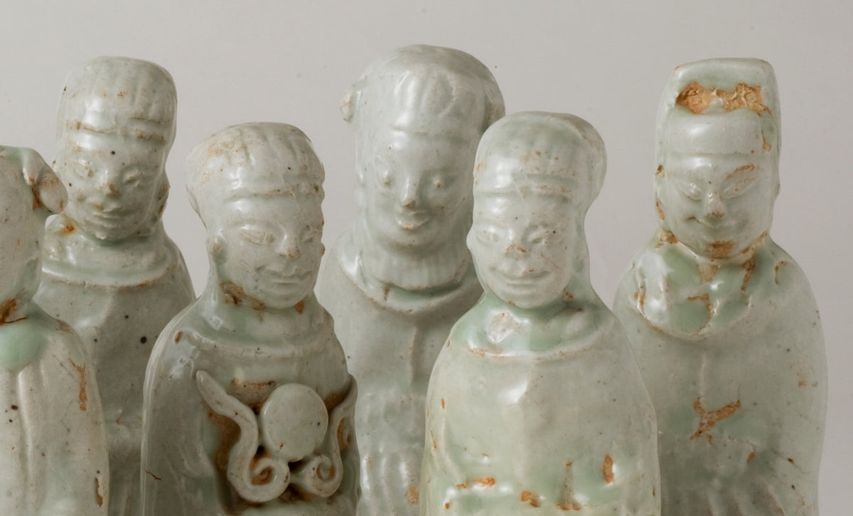 Ten Qingbai porcelain courtier figurines, Five Dynasties to Song Dynasty, with official robes and square pedestals.
