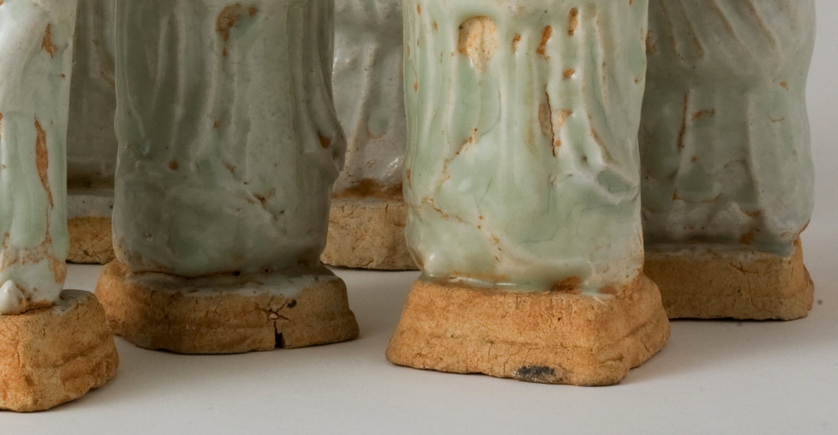 Ten Qingbai porcelain courtier figurines, Five Dynasties to Song Dynasty, with official robes and square pedestals.