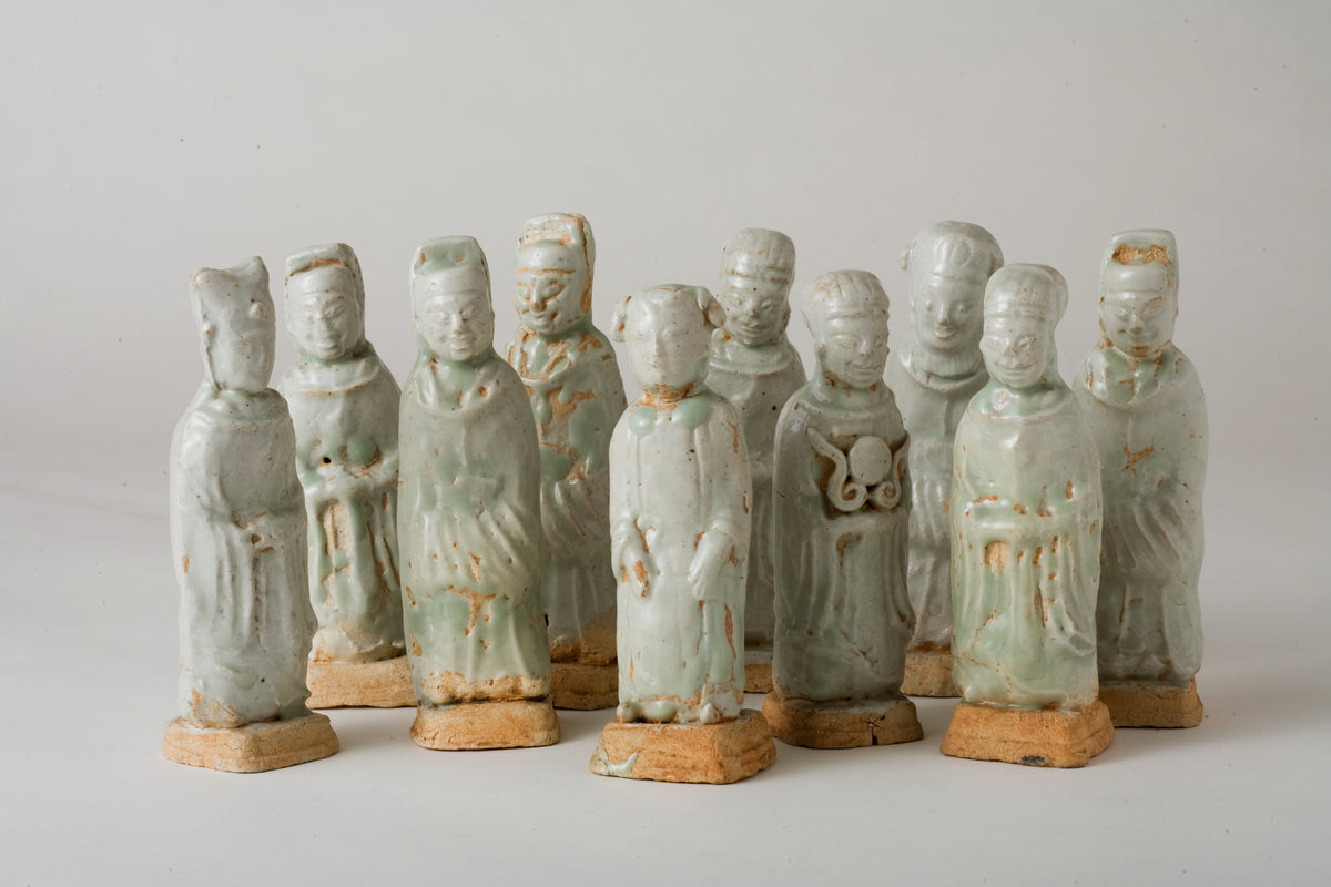 Ten Qingbai porcelain courtier figurines, Five Dynasties to Song Dynasty, with official robes and square pedestals.