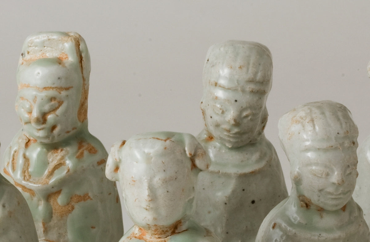 Ten Qingbai porcelain courtier figurines, Five Dynasties to Song Dynasty, with official robes and square pedestals.