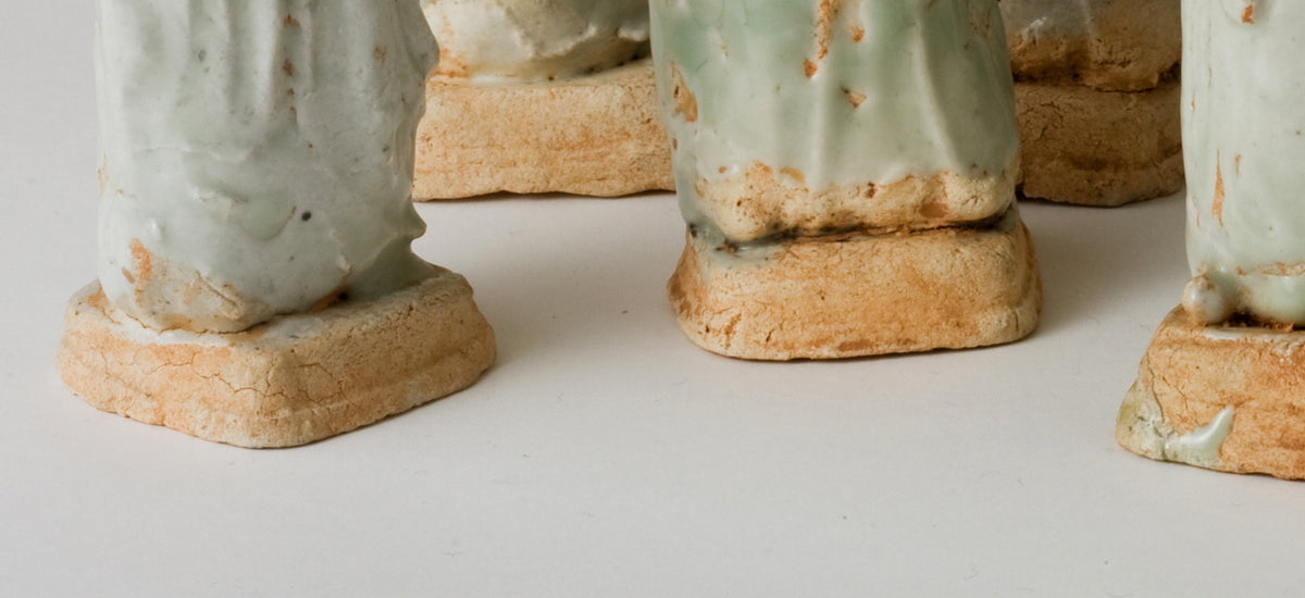 Ten Qingbai porcelain courtier figurines, Five Dynasties to Song Dynasty, with official robes and square pedestals.