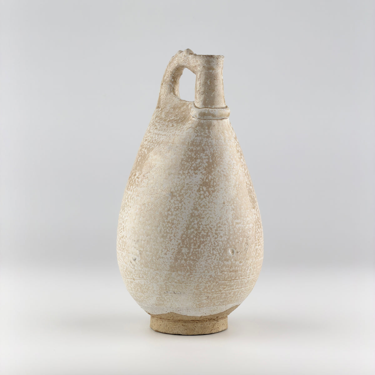 Liao Dynasty white-glazed chicken-comb ewer with a rounded body, inspired by nomadic leather water flasks.